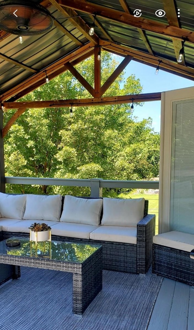 wooden deck featuring outdoor lounge area and ceiling fan