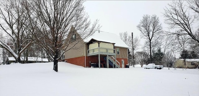 view of snow covered rear of property