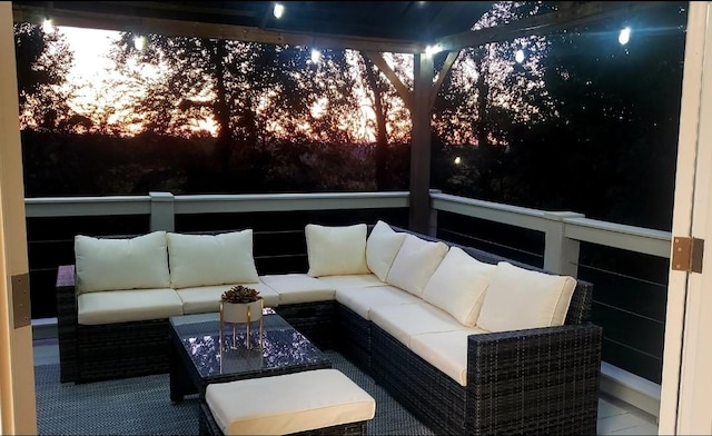 deck at dusk with an outdoor hangout area