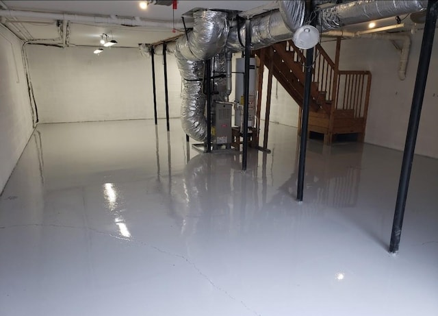 basement featuring heating unit and water heater