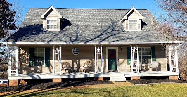 new england style home featuring covered porch