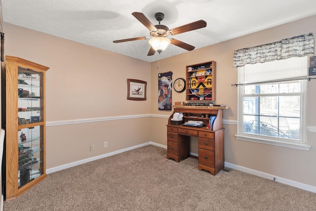 carpeted office with ceiling fan