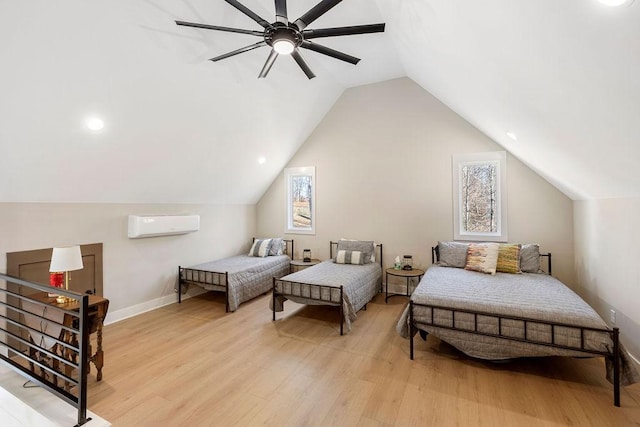 bedroom featuring a wall mounted air conditioner, light hardwood / wood-style flooring, ceiling fan, and vaulted ceiling