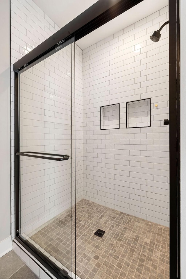 bathroom featuring an enclosed shower and tile patterned flooring