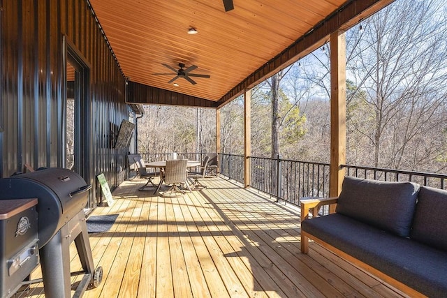 sunroom / solarium featuring wood ceiling, ceiling fan, and lofted ceiling