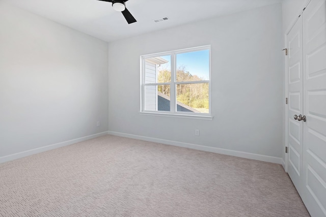 carpeted empty room featuring ceiling fan