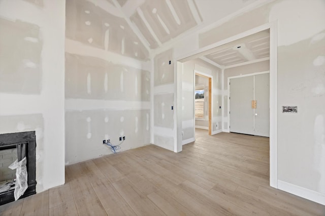 washroom featuring a fireplace and light hardwood / wood-style floors