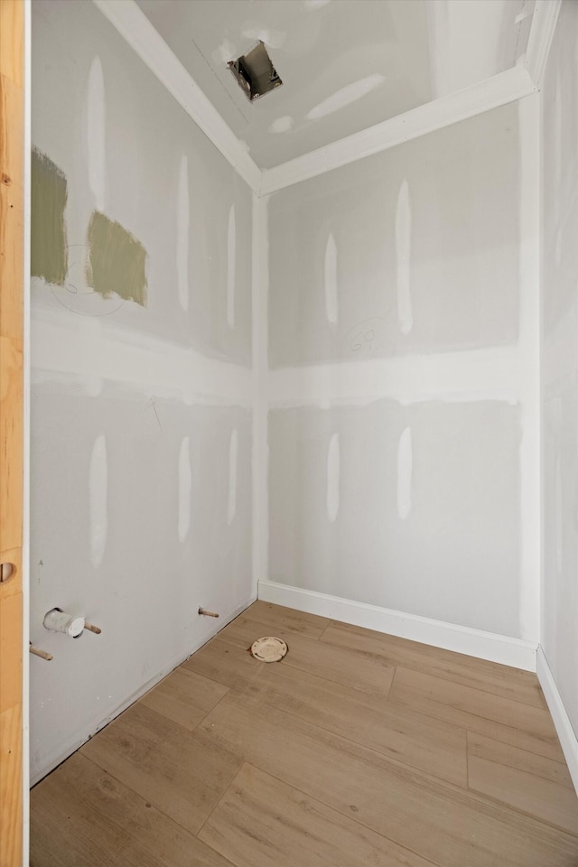 empty room featuring hardwood / wood-style flooring and ornamental molding