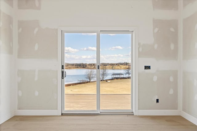 doorway to outside featuring a water view and hardwood / wood-style floors