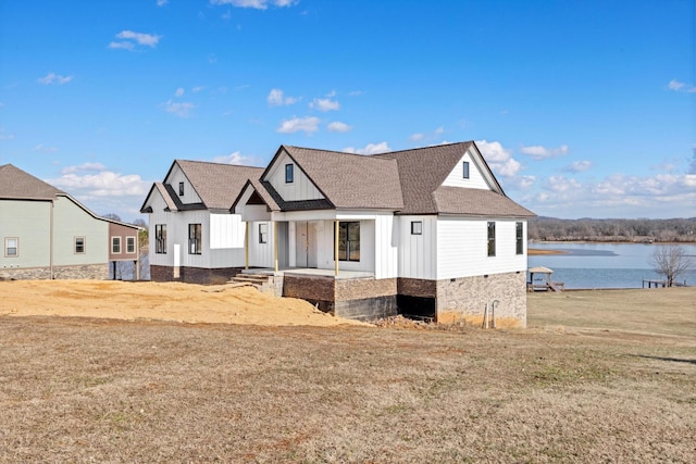 view of front of house featuring a front yard and a water view