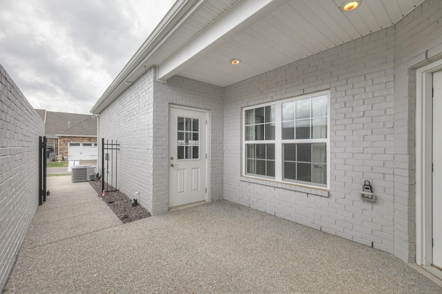 property entrance featuring cooling unit and a patio area