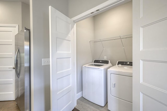 washroom featuring light hardwood / wood-style floors and independent washer and dryer