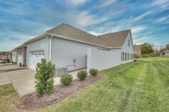 view of property exterior featuring a garage, a yard, and cooling unit