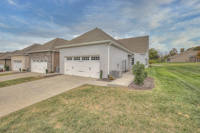 view of home's exterior featuring a garage, central AC unit, and a lawn