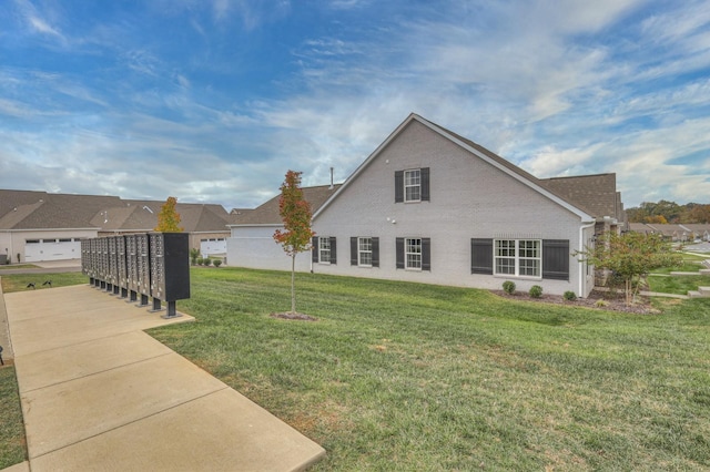 exterior space with a yard and mail boxes