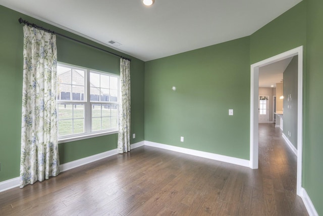 spare room with dark hardwood / wood-style flooring