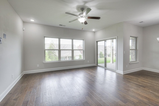 spare room with dark hardwood / wood-style floors and ceiling fan