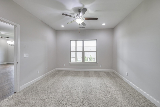 spare room featuring ceiling fan and carpet