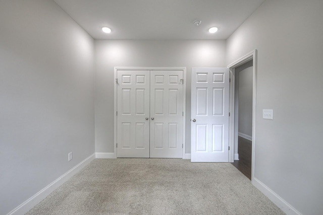 unfurnished bedroom featuring carpet flooring and a closet