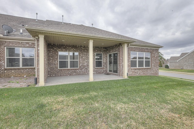 back of house featuring a patio and a yard