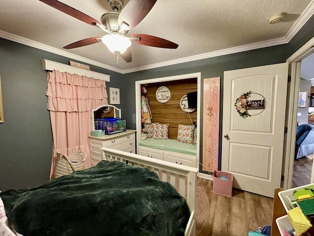 bedroom with ornamental molding, hardwood / wood-style floors, a textured ceiling, and ceiling fan