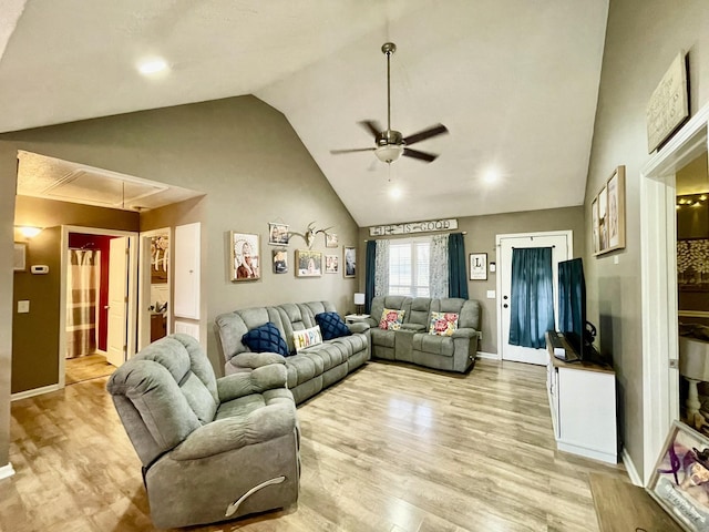 living room featuring ceiling fan, high vaulted ceiling, and light wood-type flooring