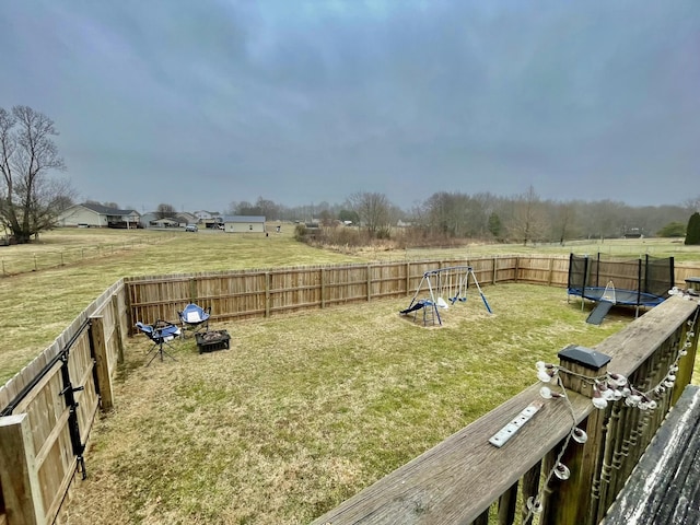 view of yard with a playground and a trampoline