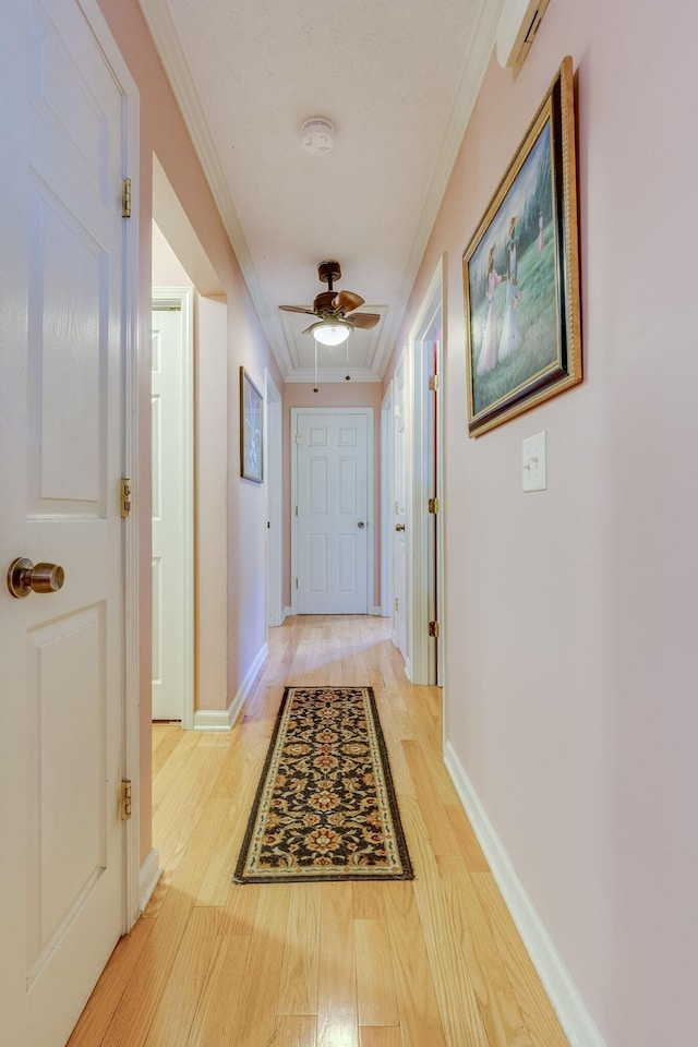 hallway featuring ornamental molding and light wood-type flooring