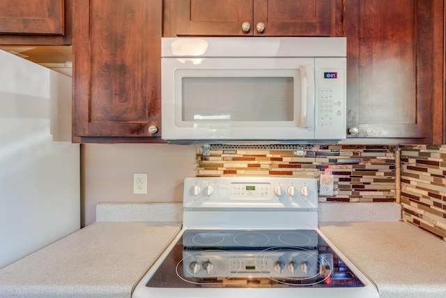 kitchen featuring white appliances and decorative backsplash