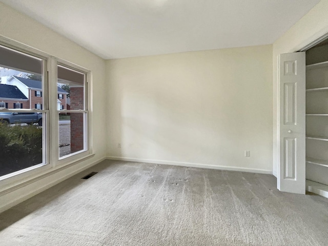 unfurnished room featuring carpet floors and a wealth of natural light