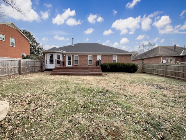 rear view of house featuring a yard