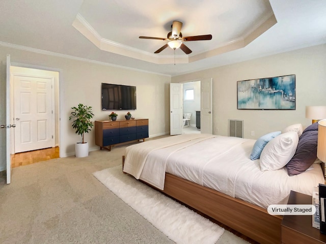 carpeted bedroom featuring a raised ceiling, ornamental molding, and ceiling fan