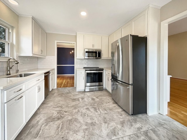 kitchen featuring white cabinetry, sink, and appliances with stainless steel finishes