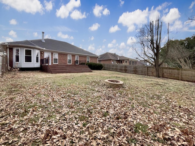 rear view of house with a fire pit