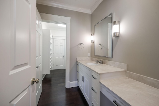 bathroom with ornamental molding, hardwood / wood-style floors, and vanity