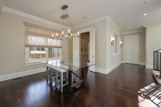 dining space with crown molding, dark hardwood / wood-style floors, and a notable chandelier