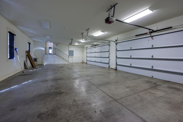 garage featuring a garage door opener and electric panel