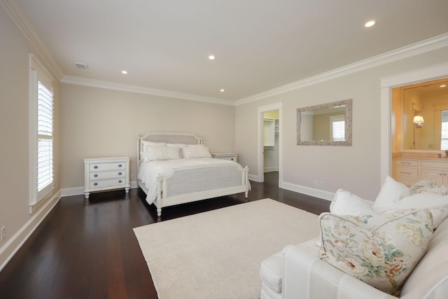 bedroom with dark wood-type flooring, ensuite bath, and crown molding