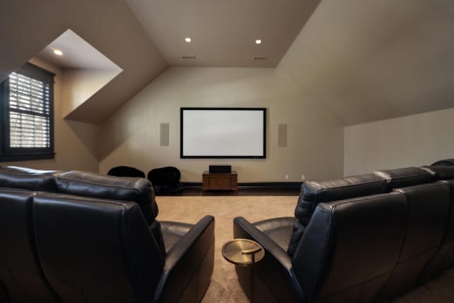 home theater room with lofted ceiling and light colored carpet