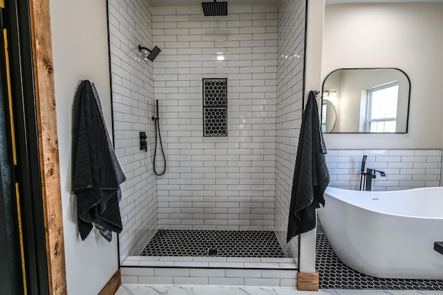 bathroom with tile walls and separate shower and tub