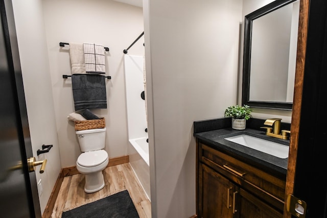 full bathroom with shower / tub combination, vanity, hardwood / wood-style floors, and toilet