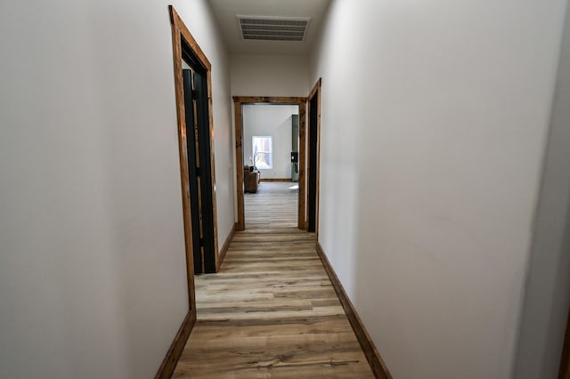 hallway with light hardwood / wood-style flooring