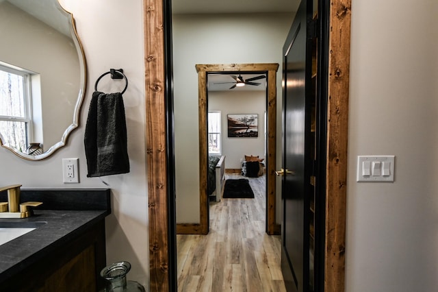 bathroom featuring ceiling fan, vanity, and hardwood / wood-style floors