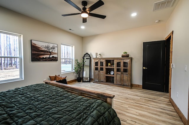 bedroom with light hardwood / wood-style flooring and ceiling fan