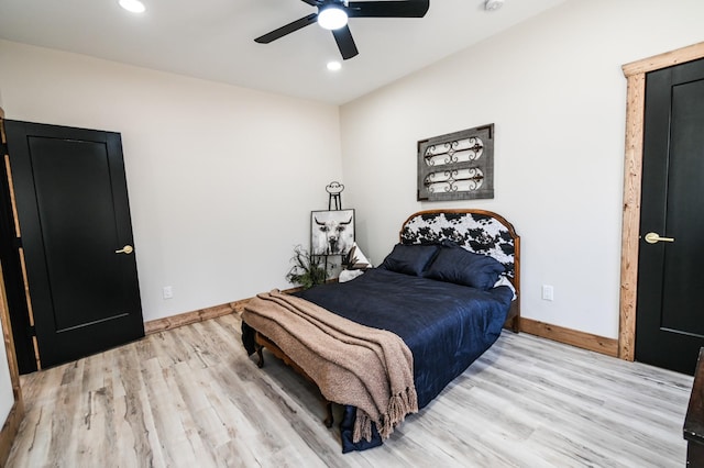 bedroom with ceiling fan and light hardwood / wood-style flooring