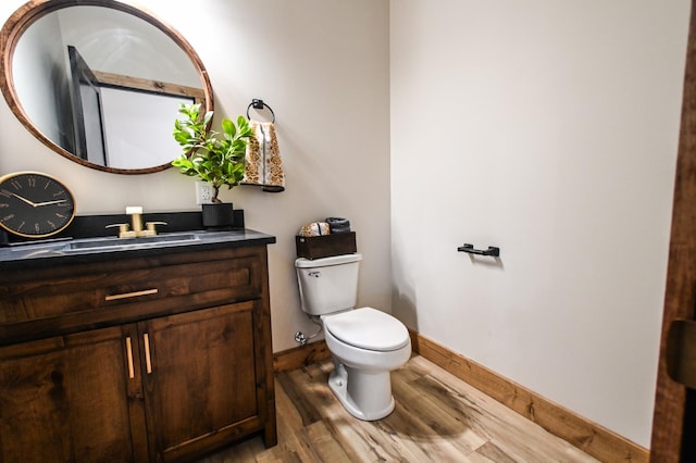 bathroom featuring vanity, hardwood / wood-style floors, and toilet