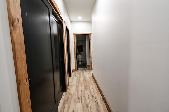 corridor with light hardwood / wood-style floors