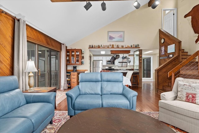 living room featuring wood-type flooring and vaulted ceiling