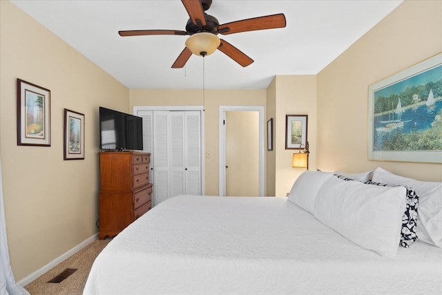 carpeted bedroom featuring a closet and ceiling fan