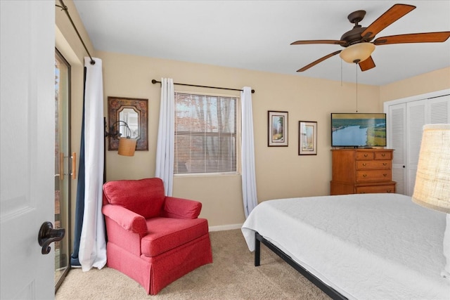 bedroom with multiple windows, light colored carpet, ceiling fan, and a closet